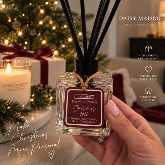 Daisy Maison personalised Christmas reed diffuser with burgundy family tag in a warm festive home setting