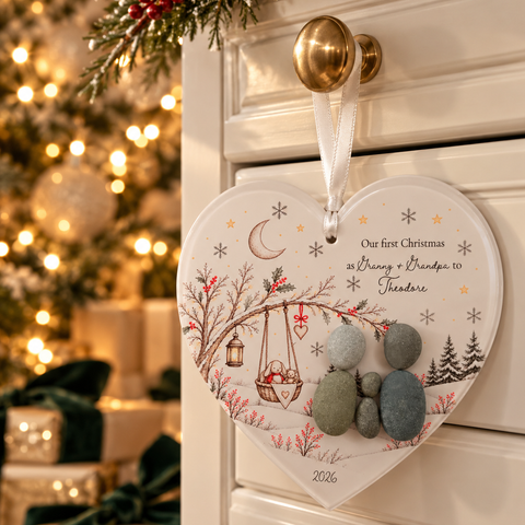 First Christmas pebble heart decoration hanging from a drawer knob: Our first Christmas as Granny + Grandpa to Theodore, 2026