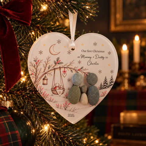 Personalised Our First Christmas pebble heart decoration on a Christmas tree: Our first Christmas as Mummy + Daddy to Charlie, 2026