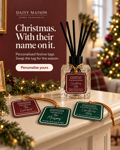 Personalised Christmas reed diffuser on a festive mantel with burgundy and green family tag designs
