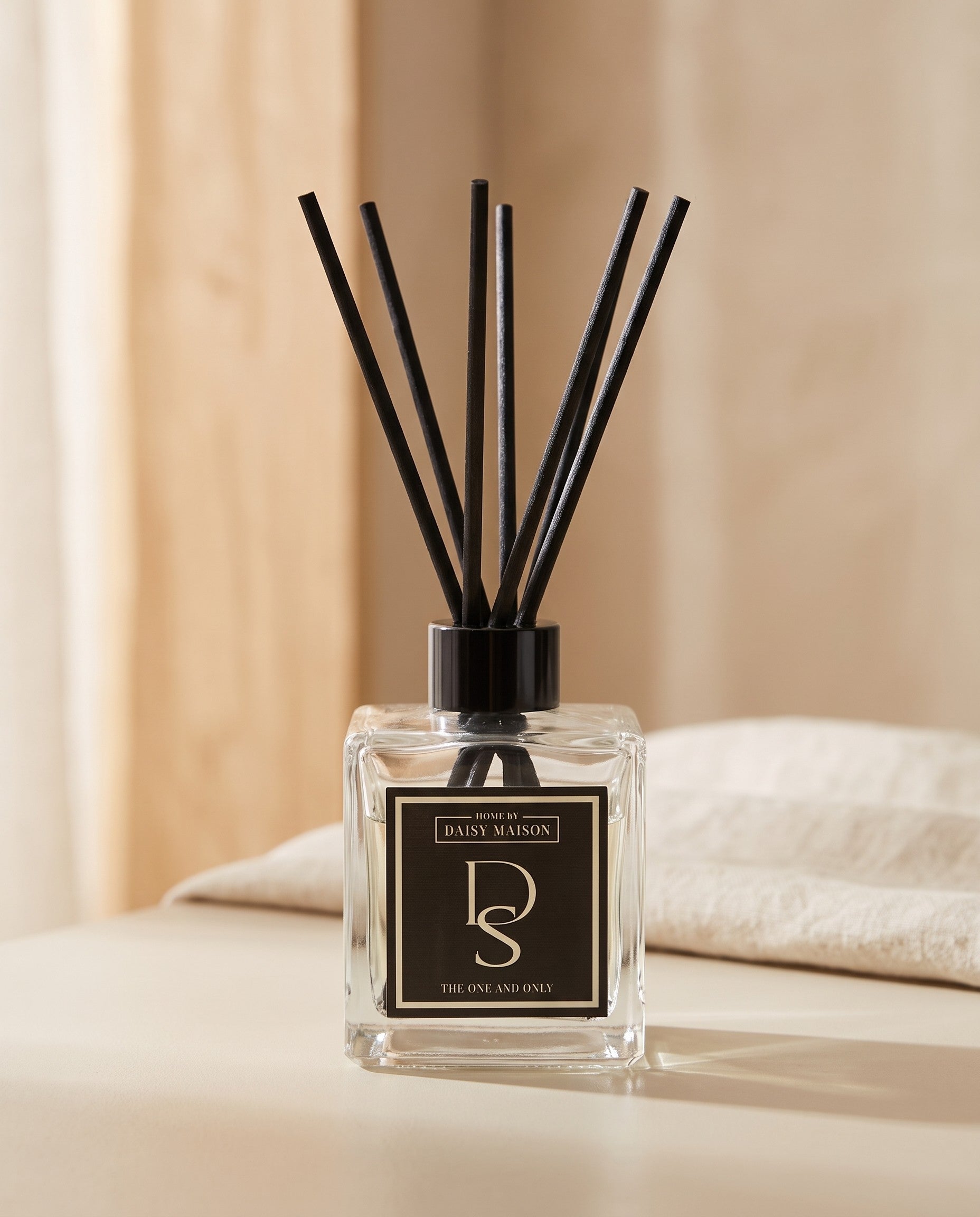 Personalised reed diffuser on a putty surface