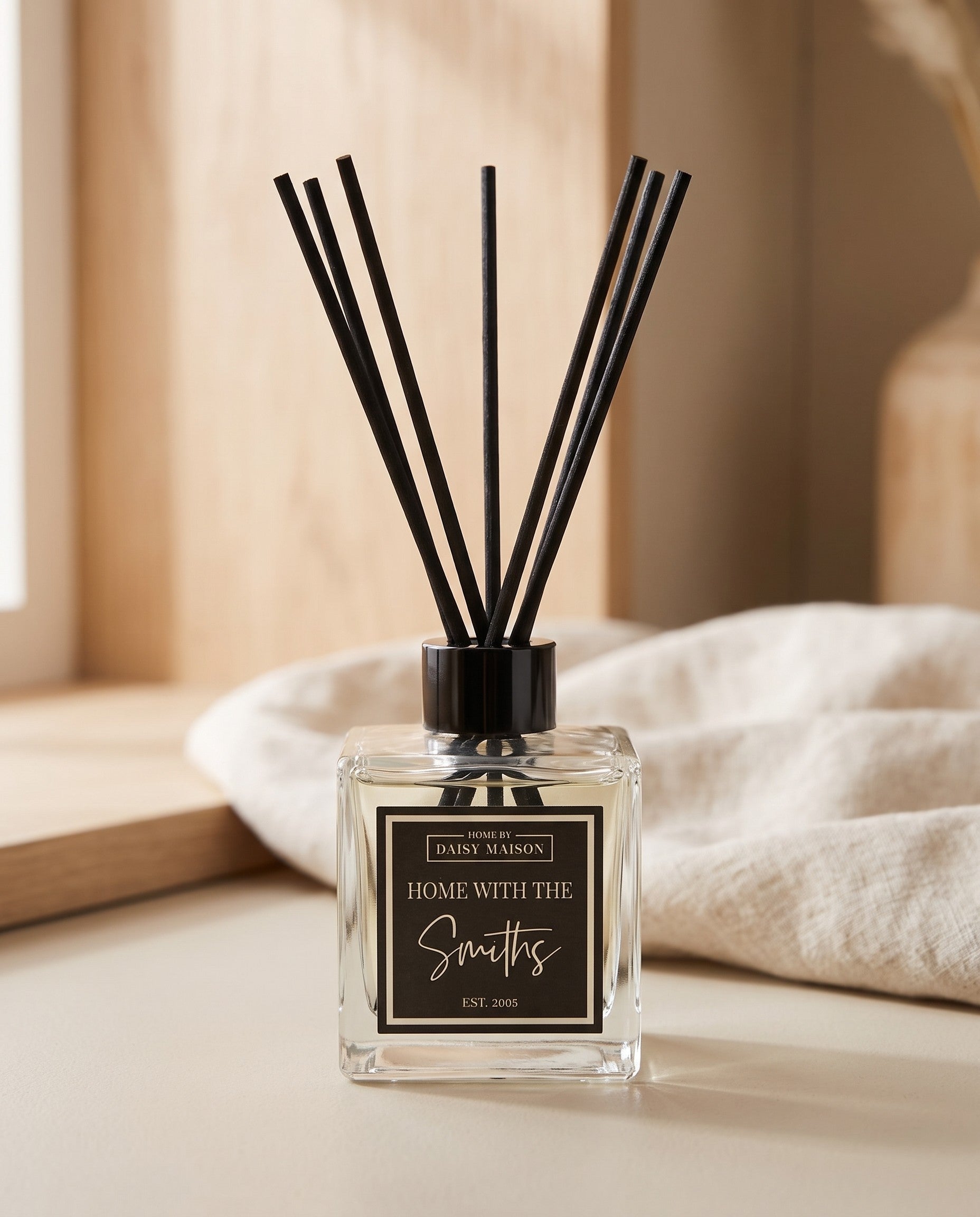 Personalised family reed diffuser on a putty surface