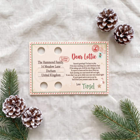 Personalised acrylic Elf Arrival Postcard laid flat showing the printed verse and name spaces