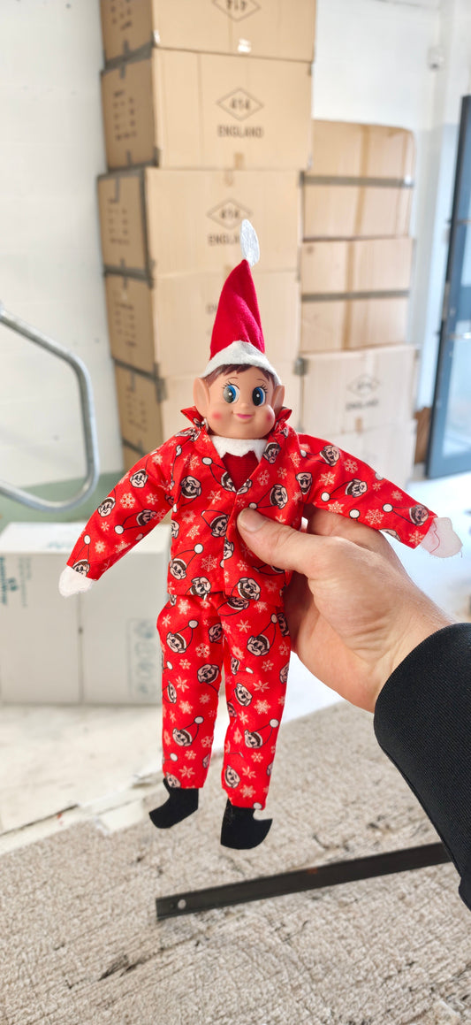 The real red elf-print pyjamas from the Night Shift Set, worn by our Plush Elf Friend