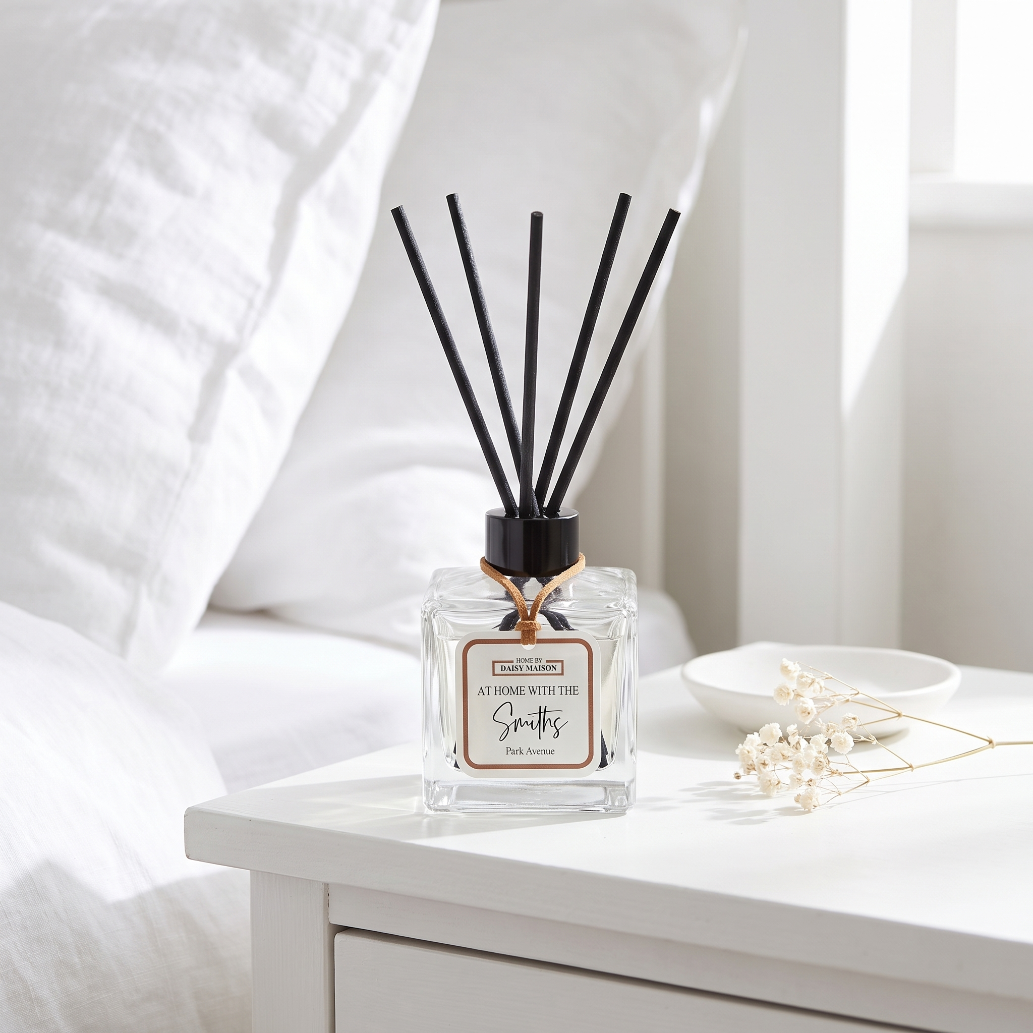 Personalised family reed diffuser on a bright white bedside table