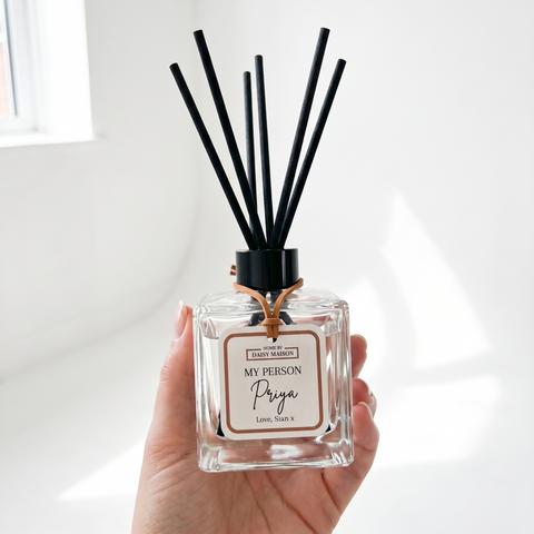 Personalised friendship reed diffuser held up in a bright airy room, My Person, Priya