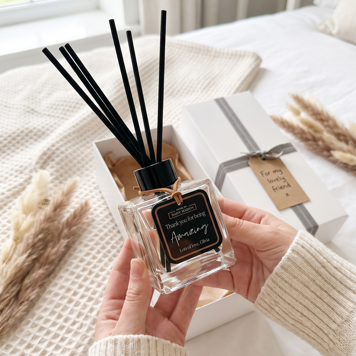Personalised friendship reed diffuser with black tag being unboxed as a gift, Thank You For Being Amazing, Lots of love Olivia