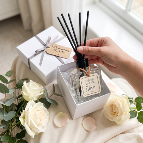 Personalised Mr & Mrs reed diffuser being lifted from its gift box, With all our love Ella & Tom, Mr & Mrs Ellison