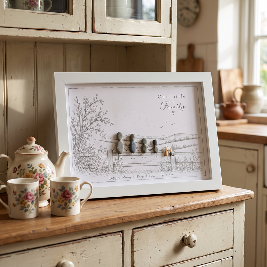 ‘Our Little Family’ pebble picture on a painted dresser beside a floral teapot and mugs