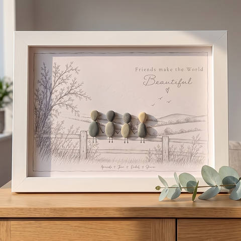 ‘Friends make the World Beautiful’ personalised pebble picture in a white frame on an oak sideboard