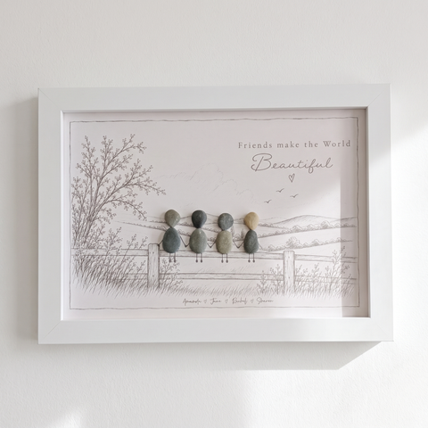 ‘Friends make the World Beautiful’ pebble picture hanging on a bright white wall