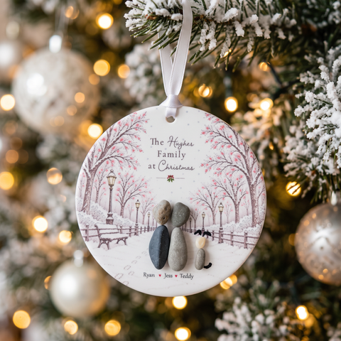 Couple and dog pebble Christmas decoration hanging on a frosted Christmas tree