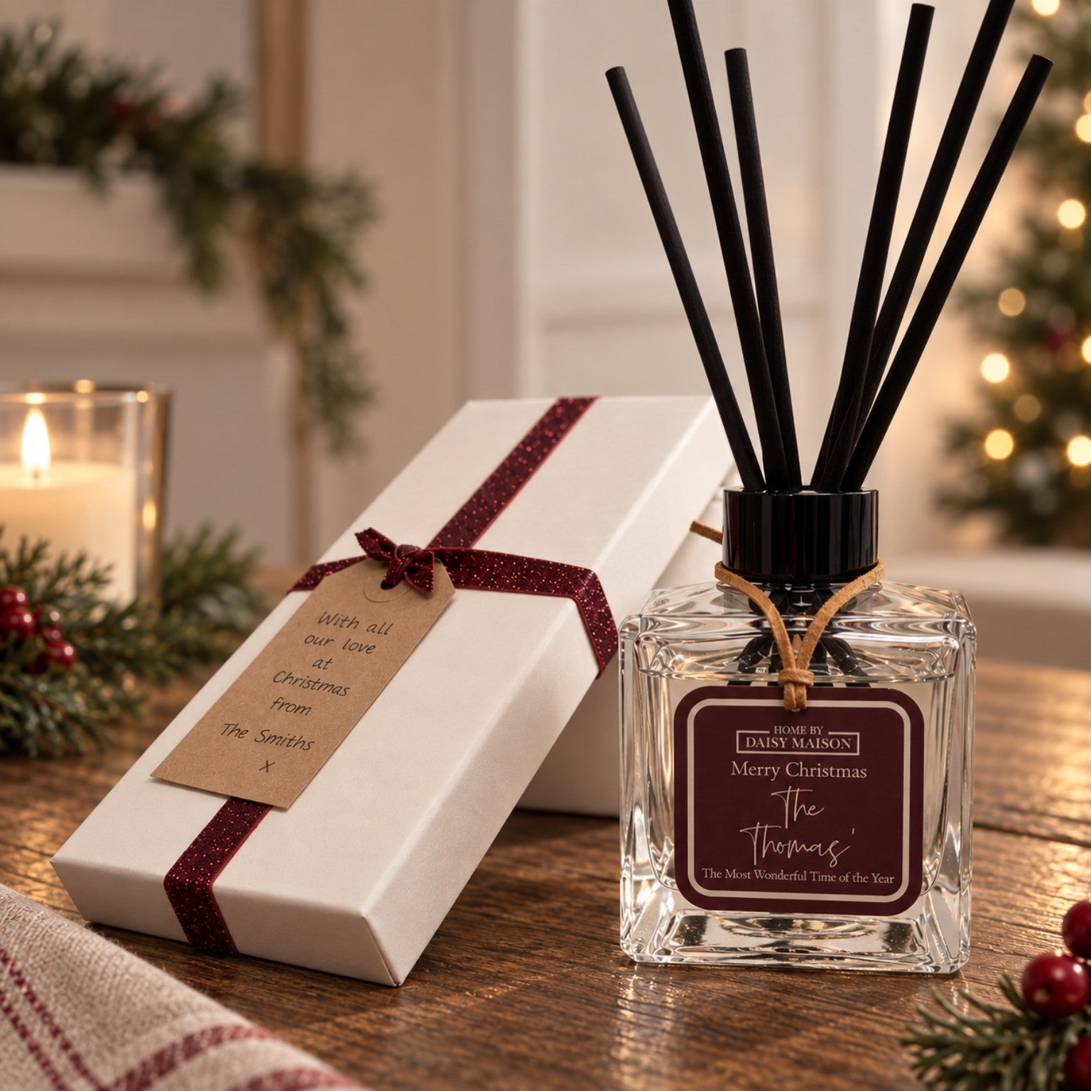 Personalised Christmas reed diffuser with burgundy tag and gift box in a warm festive setting