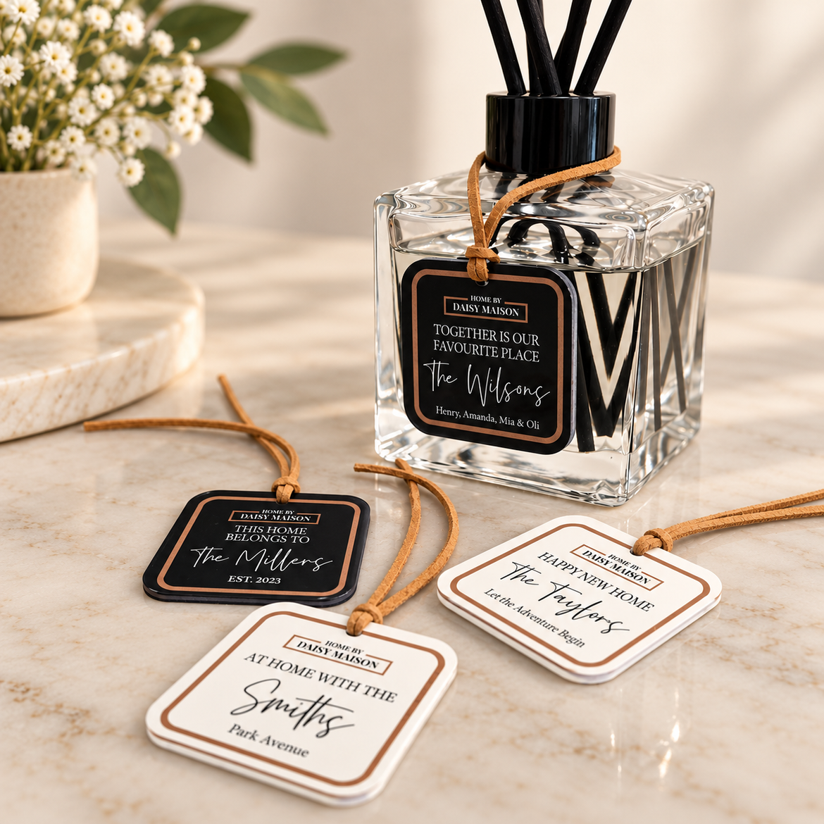 Personalised family reed diffuser with family name tags on an elegant neutral marble background