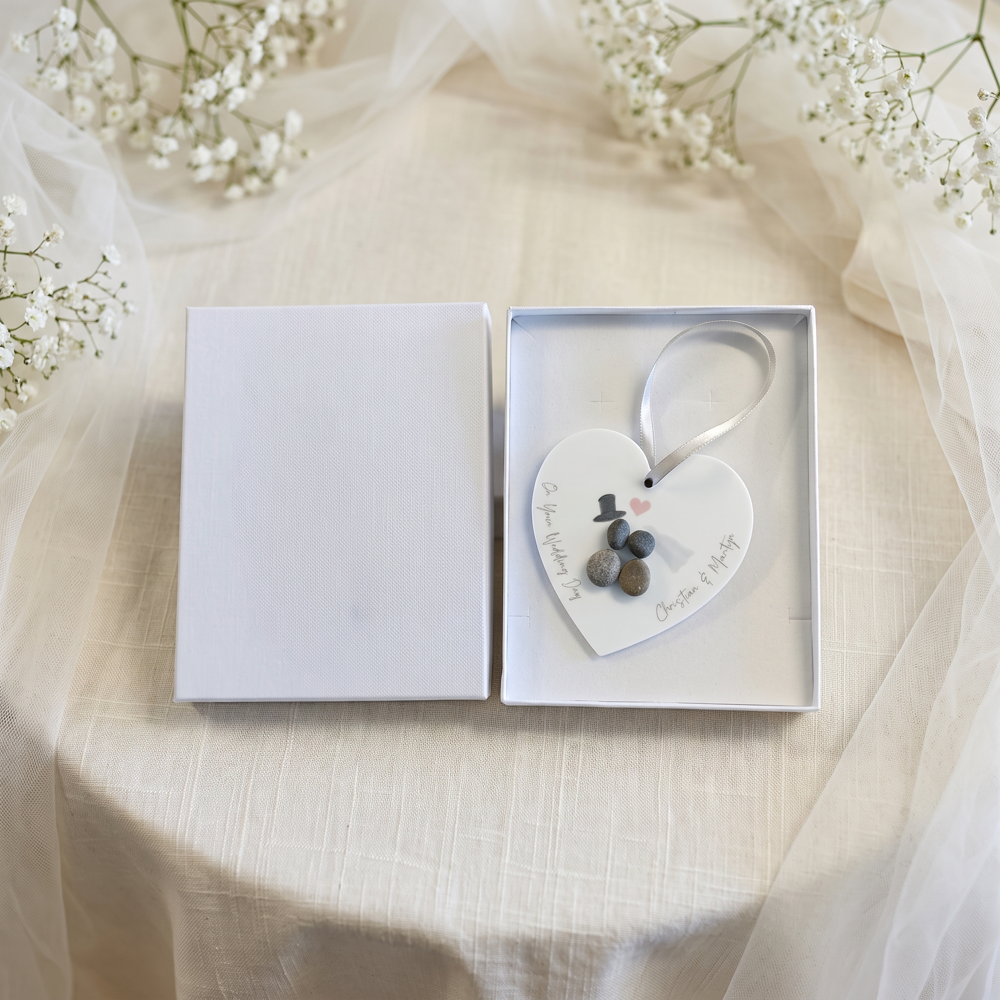 Small white gift box with a personalised wedding pebble heart