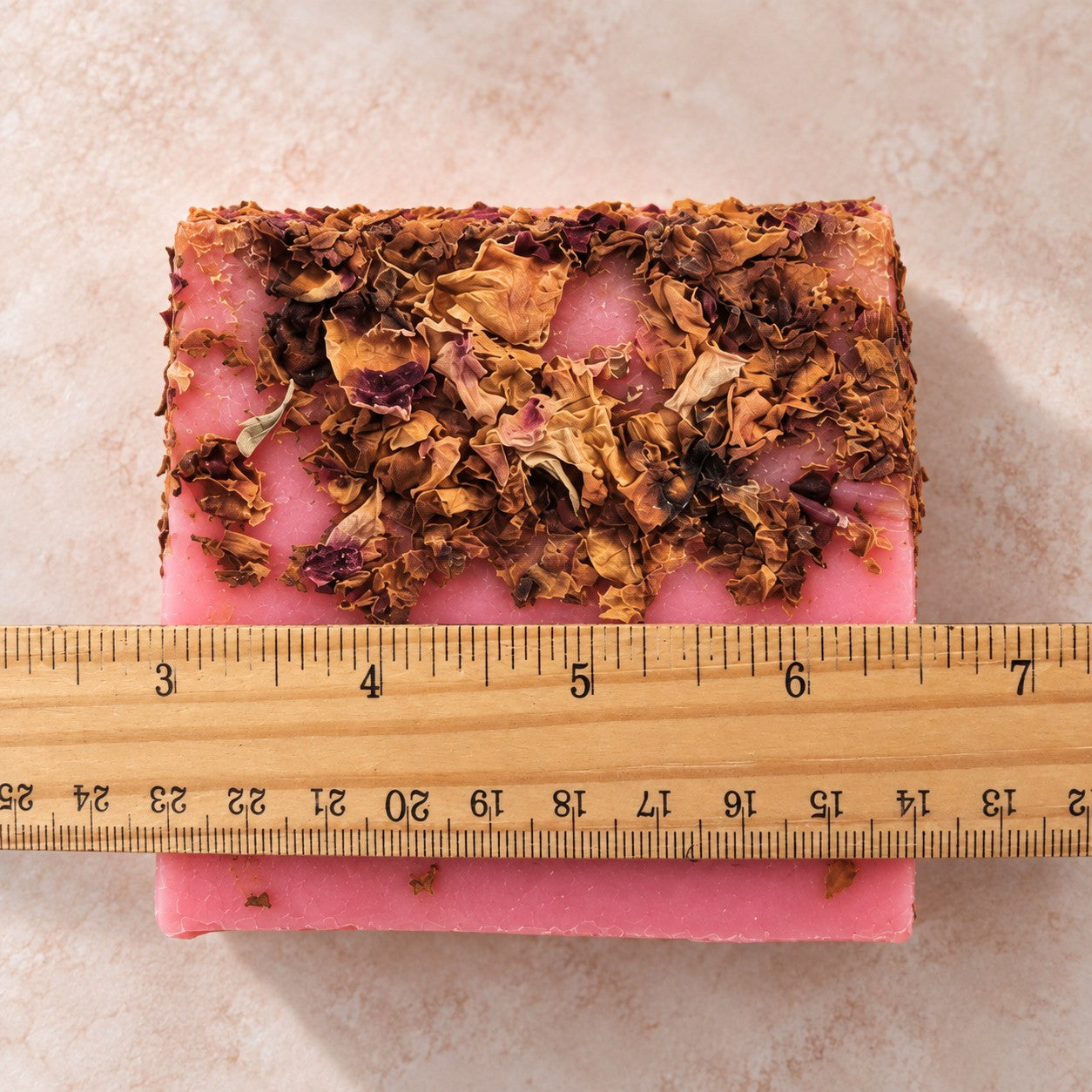 Rose & Rose Petals soap slice next to a ruler to show its size