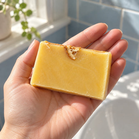 Slice of Sunshine soap slice held in an open hand