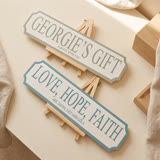 Two personalised street signs standing on wooden display easels